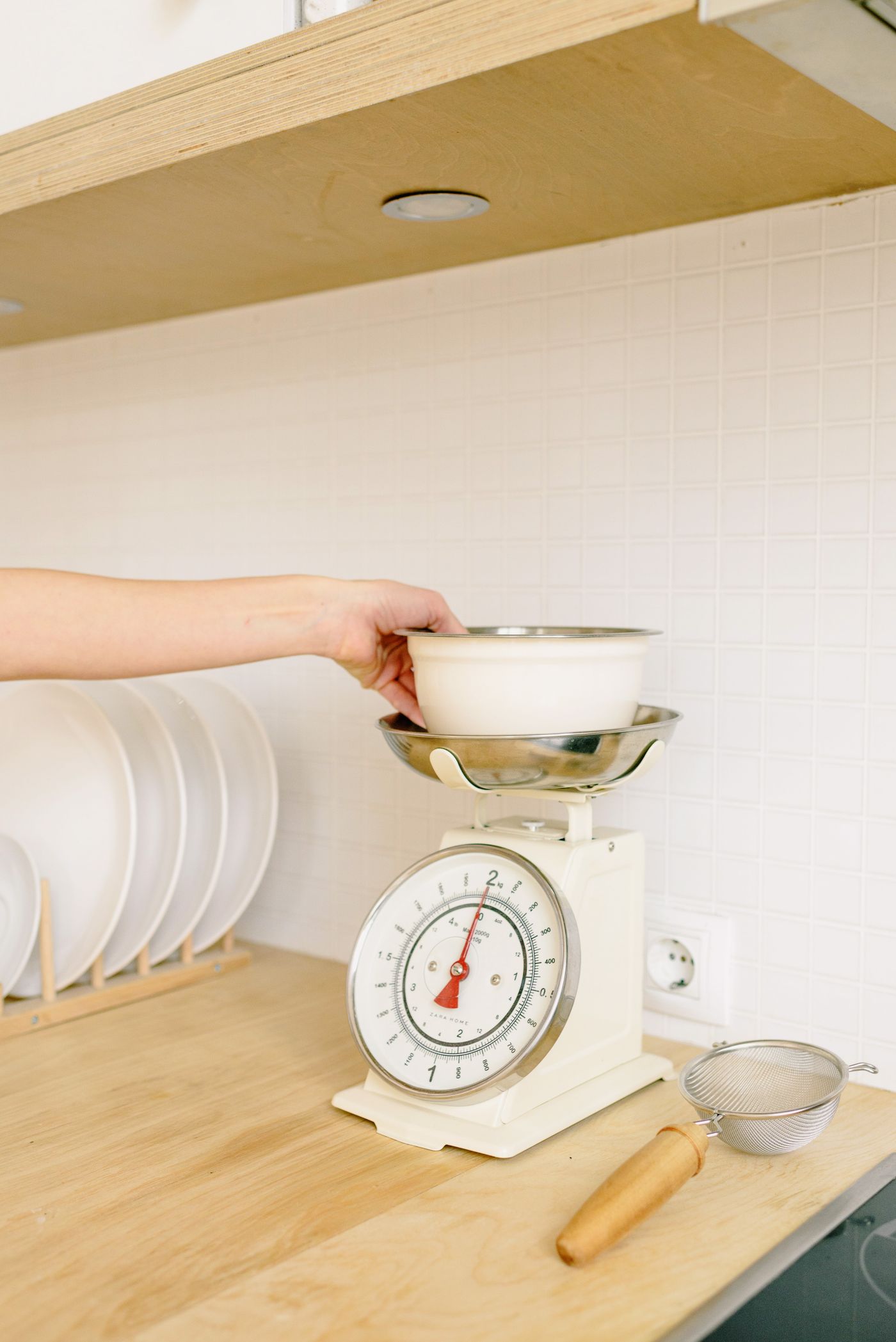 Small bowl being weighed on a kitchen scale